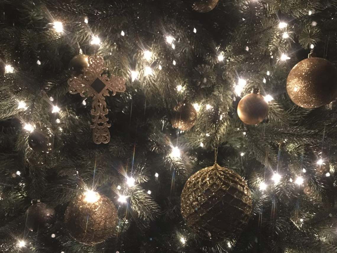 A christmas tree with lights and ornaments on it.