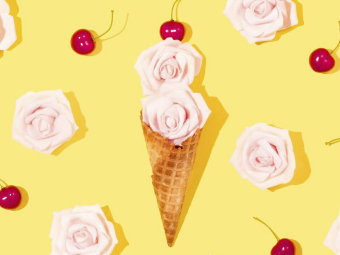 A cone with roses and cherries on it.