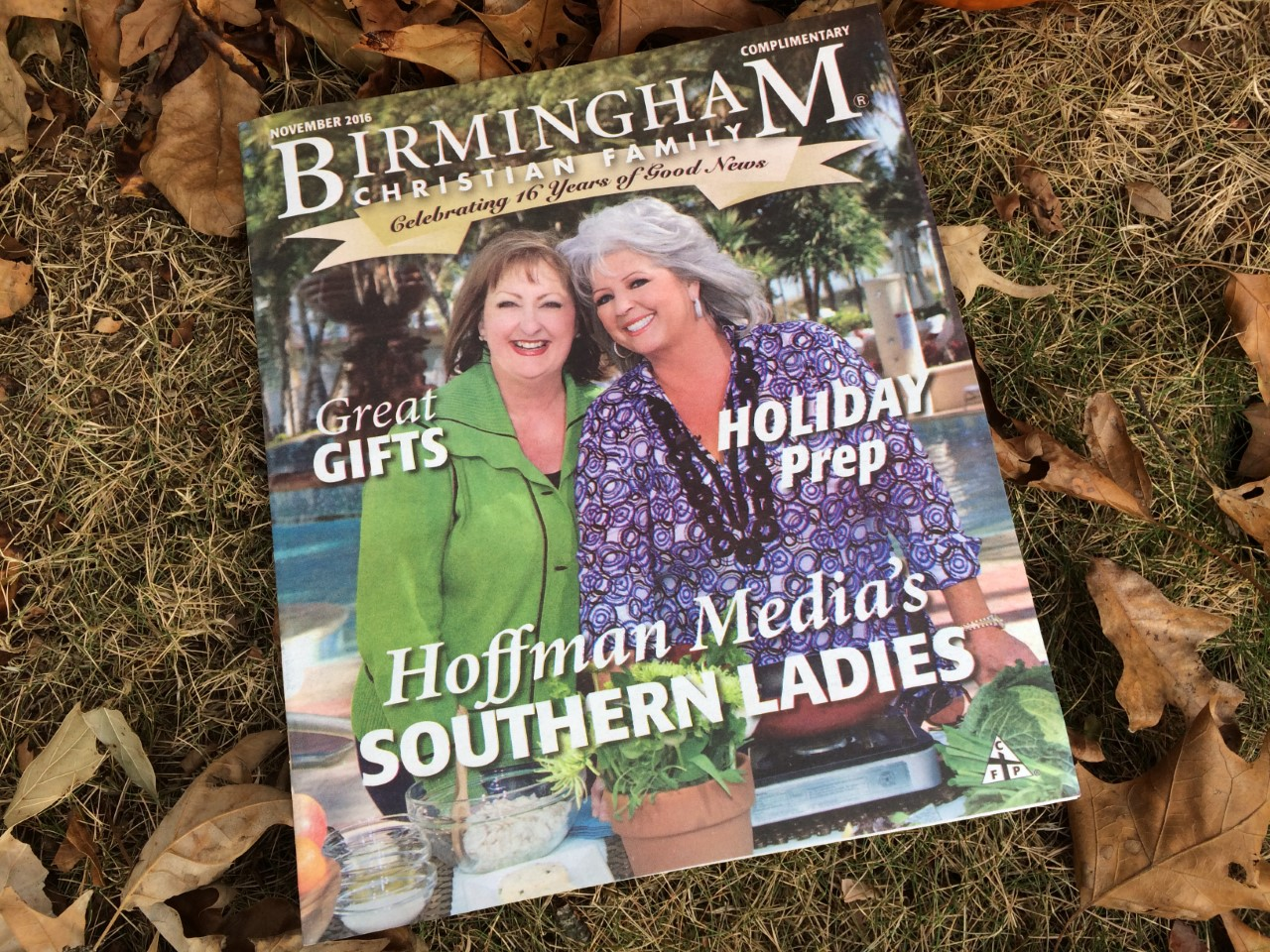 A magazine cover with two women sitting on top of leaves.