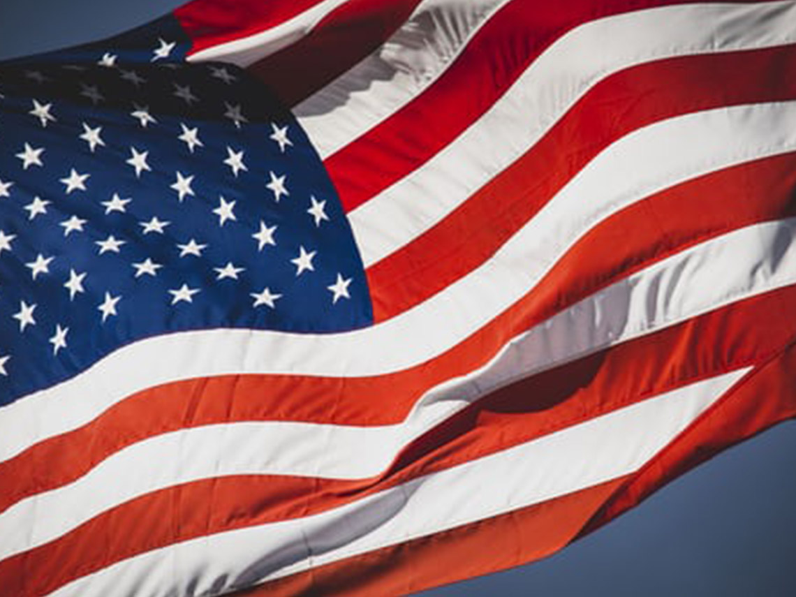 A close up of the american flag waving in the wind