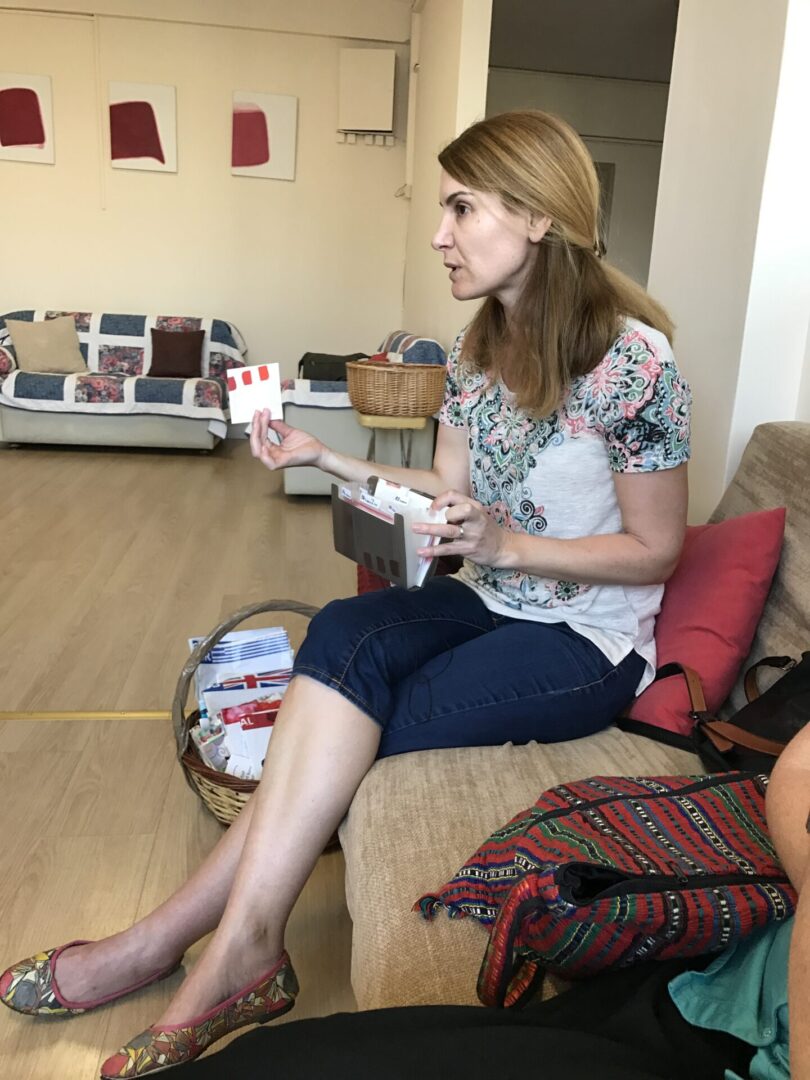 A woman sitting on the couch holding a wii controller.