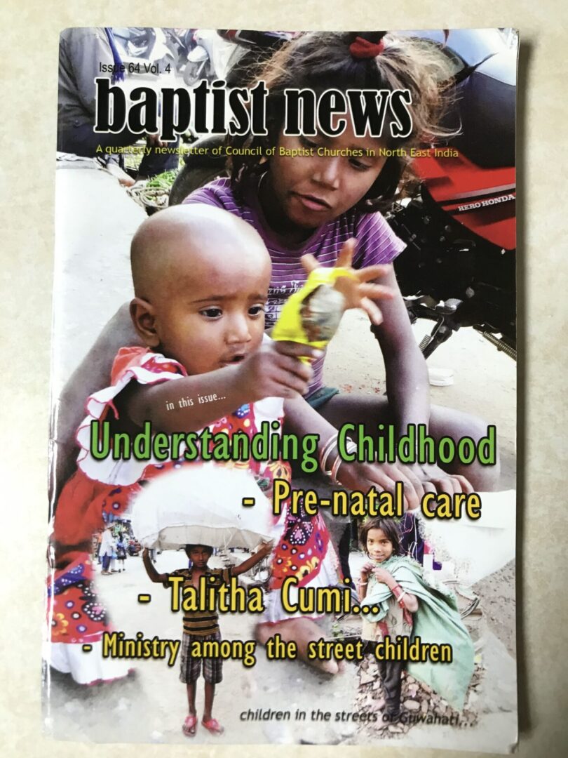 A magazine cover with an image of a woman feeding her child.