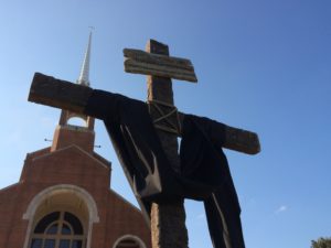 A cross and the church are in front of it.