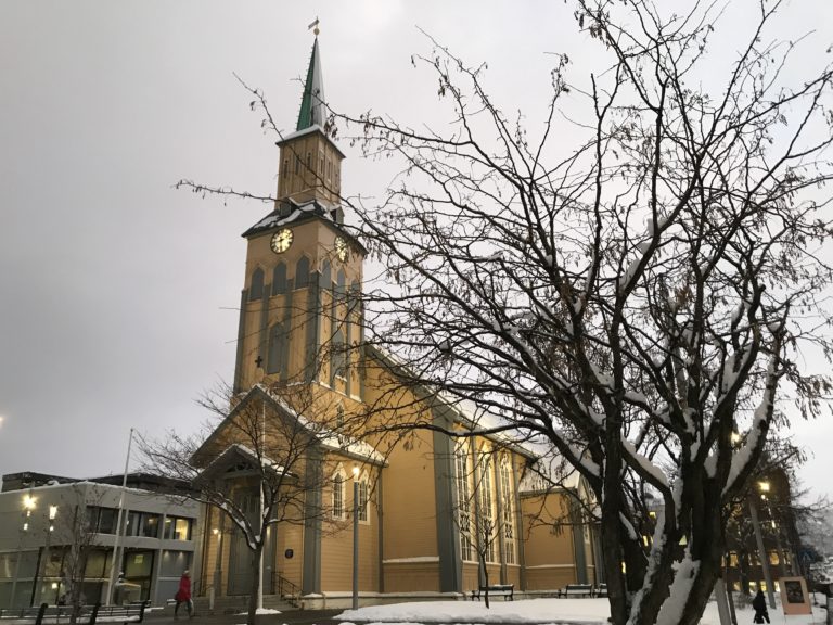 A church with a steeple and clock on the top of it.