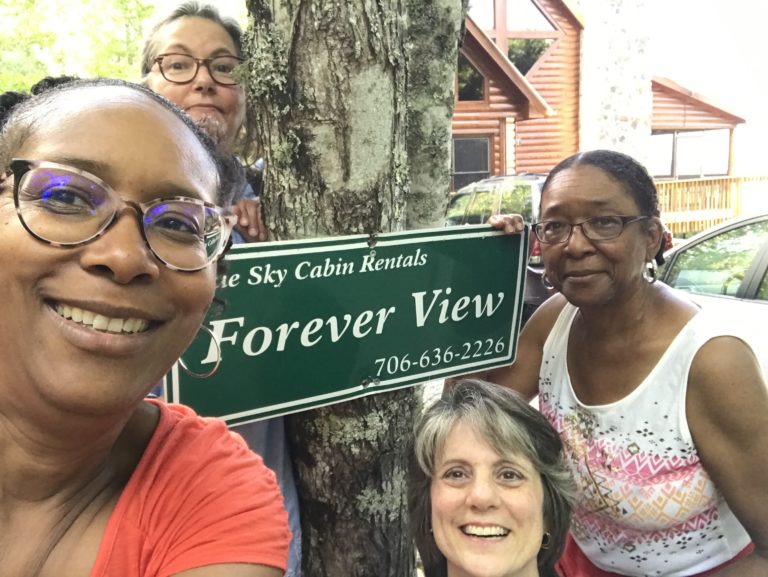 A group of people standing next to a tree.