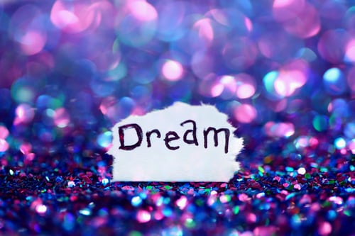 A piece of paper that says " dream ".