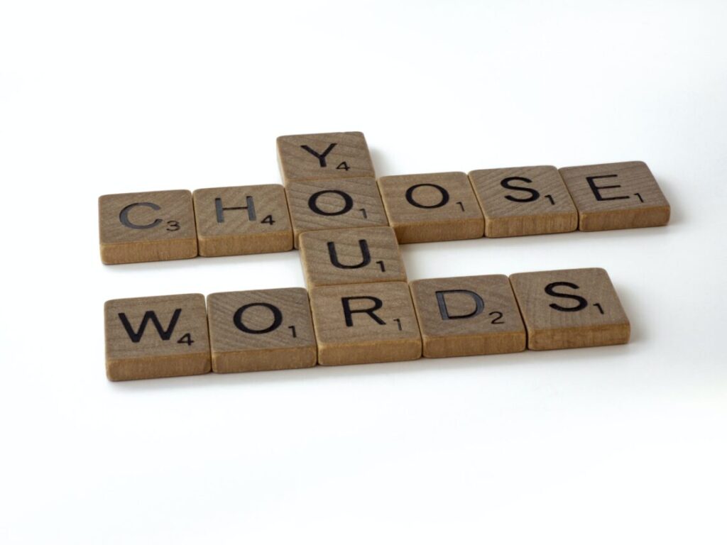 A scrabble tile letter that says choose your words.