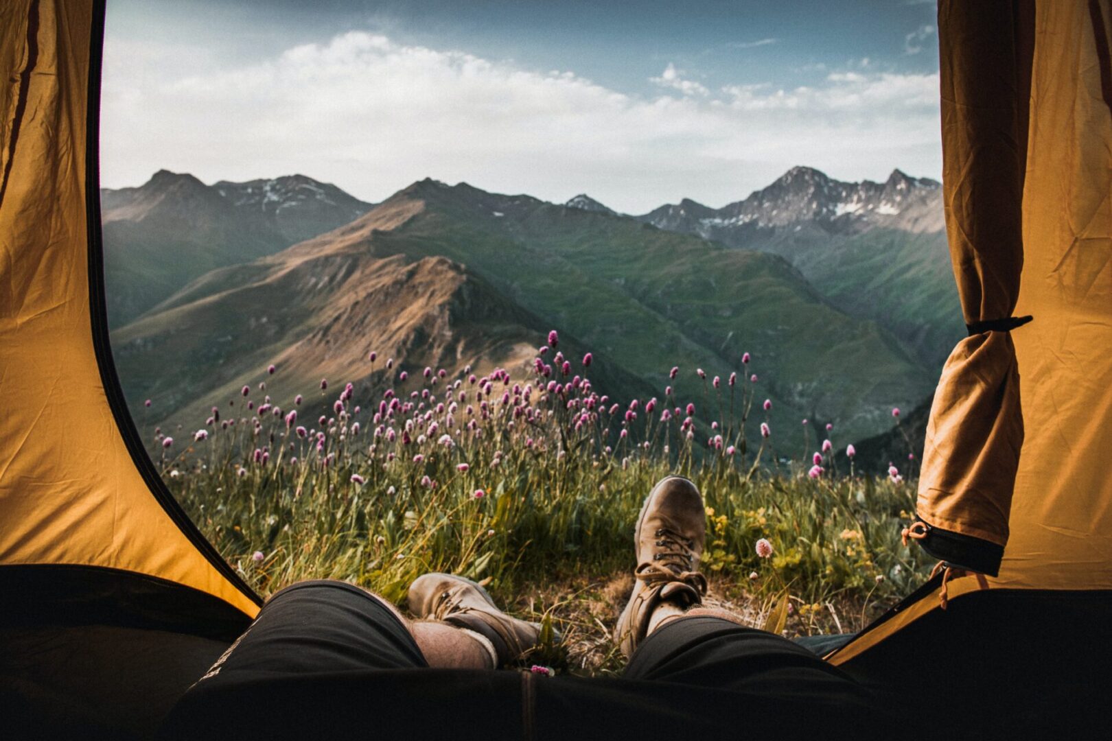 A person sitting in the grass on top of a hill.