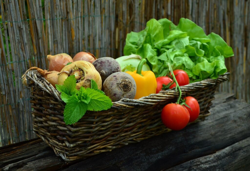 A basket of vegetables on top of a table.