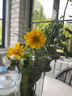 A vase of flowers on the table outside