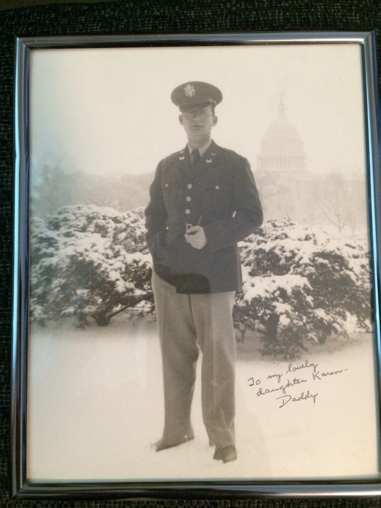 A man in uniform standing on top of a snow covered slope.